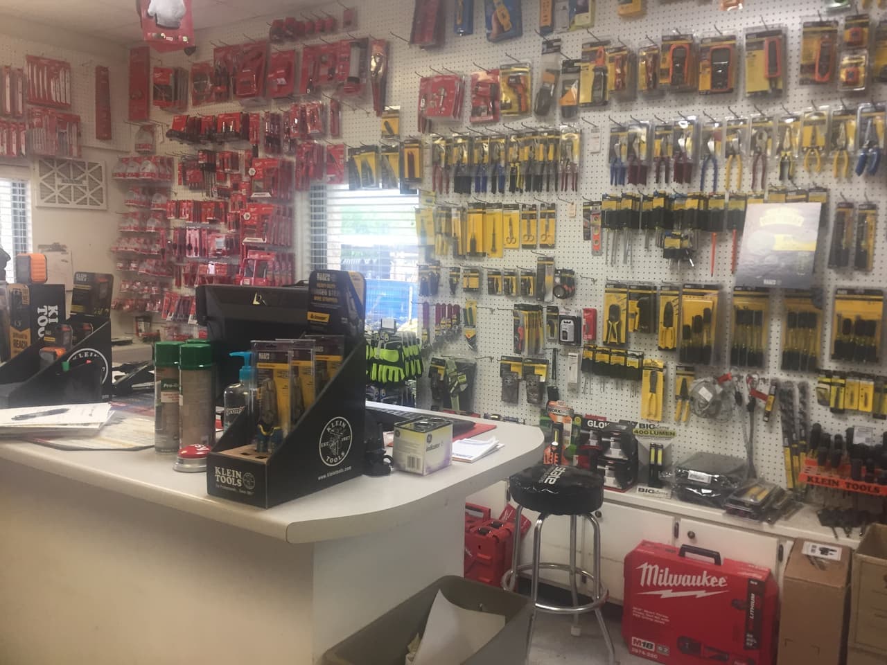 Service counter and pegboard wall of hand tools and power tool accessories at Smith Supply in Stephenville, TX